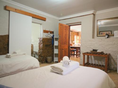 a bedroom with two beds with towels on them at Barn Guesthouse in Kroonstad