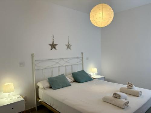 a bedroom with a large bed with towels on it at Villa Son Saura in Cala en Forcat