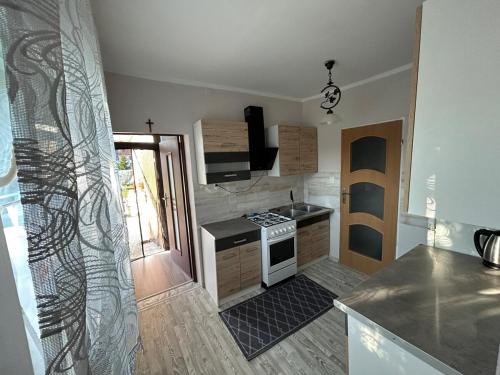 a kitchen with a stove and a counter top at Agroturystyka Willy in Sarnowo