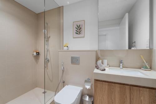a bathroom with a toilet and a sink and a shower at Amazing 2BR Home Burj Khalifa View Steps Walk to DubaiMall in Dubai