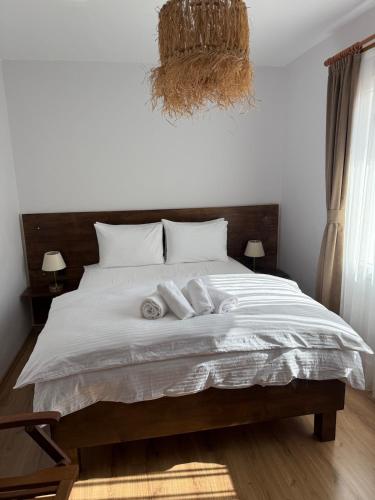 a bedroom with a bed with two towels on it at Urla The Orange House in Kuscular
