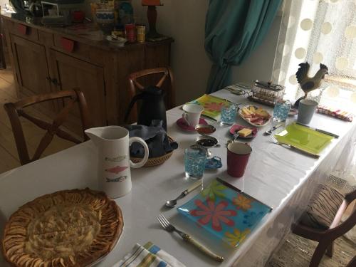 a table with a white table with food on it at La Tour Charlemagne in Château-Chalon