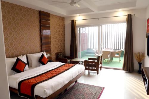 a hotel room with a bed and a balcony at Airport Hotel in New Delhi