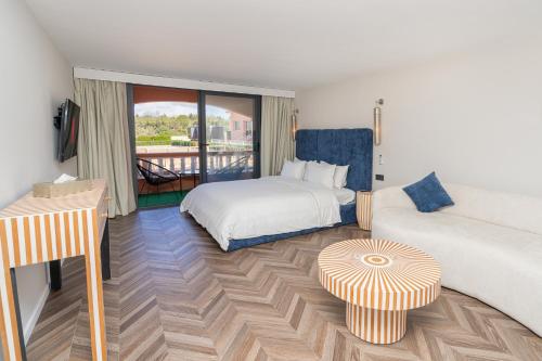 a hotel room with two beds and a balcony at Royal Club Equestre Detroit Bed and Breakfast in Tangier