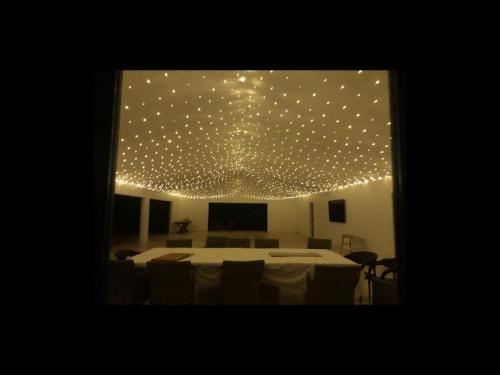 a room with a table with lights on the ceiling at Great friends and family getaway in Annangrove