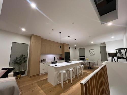 a large kitchen with a white counter top in a room at Stunning executive family home! in Paraparaumu
