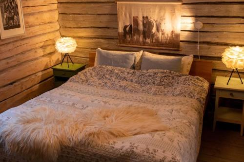 a bedroom with a bed with a furry blanket on it at Cozy Cabin Retreat in Scenic Valley, E6 south of Trondheim in Storen
