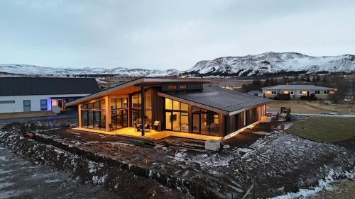 a modern house with glass walls on aestead at Bright & spacious family villa on the south coast in Ölfus