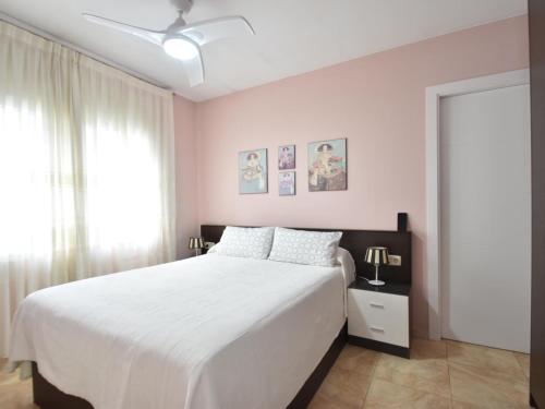 a bedroom with a white bed and a window at Flores in Begur