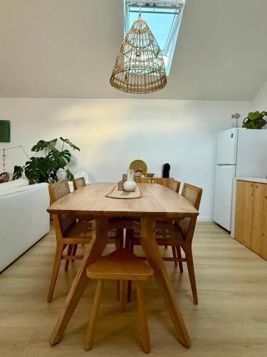 a dining room table with chairs and a chandelier at Palmeirinha Guest House in Sintra