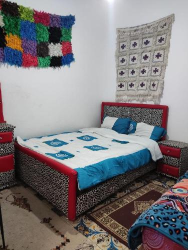 a bed in a room with a blanket on it at Coopérative Tourisme Social Maison D'hôtes in Midelt