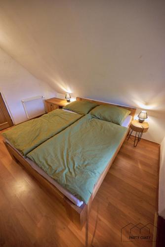 a large bed in a bedroom with two lamps at Chalet The Great Gatsby in Karlovy Vary