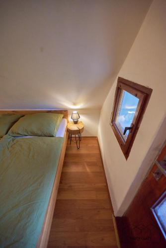 a small bedroom with a bed and a window at Chalet The Great Gatsby in Karlovy Vary