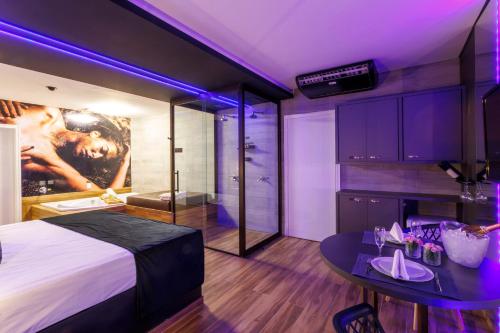 a bedroom with a large bed with purple lighting at Medieval Motel SPA - Porto Alegre-RS in Porto Alegre
