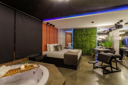 a hotel room with a bed and a bath tub at Medieval Motel SPA - Porto Alegre-RS in Porto Alegre