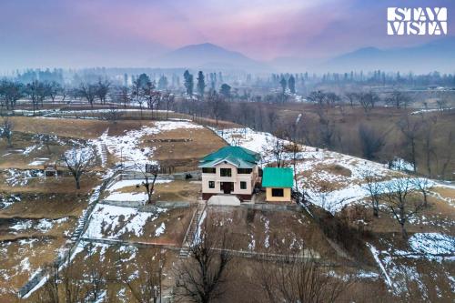 an aerial view of a house with a green roof at StayVista at Riverscape with Views, WiFi, Heater in Srinagar
