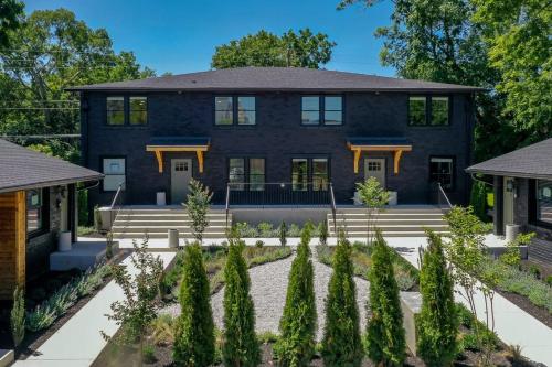 an exterior view of a blue house with trees at The Nomad by AvantStay in Nashville