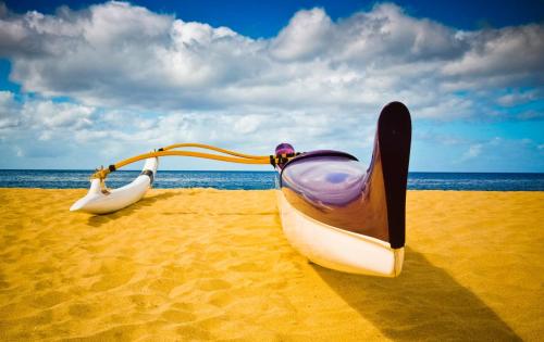 two boats sitting on the sand on the beach at Studio Nene by AvantStay Chic Cozy King Bed in Waianae
