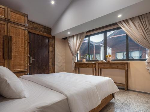 a bedroom with a large white bed and a window at Ailee Villa&Hotel TamCoc in Ninh Binh