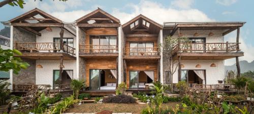 an image of a house with wooden balconies at Ailee Villa&Hotel TamCoc in Ninh Binh