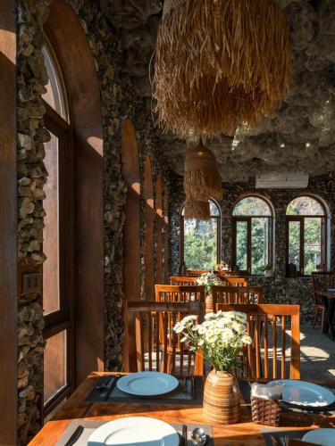 a dining room with a table and chairs and a chandelier at Ailee Villa&Hotel TamCoc in Ninh Binh