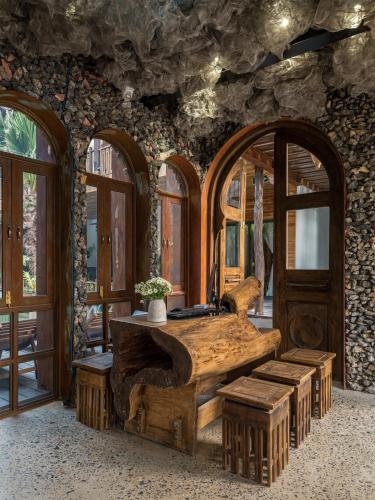 a wooden desk in a room with windows at Ailee Villa&Hotel TamCoc in Ninh Binh