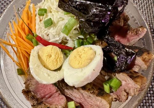 a plate of food with meat and eggs and vegetables at Hotel Oasis Port Barton in San Vicente