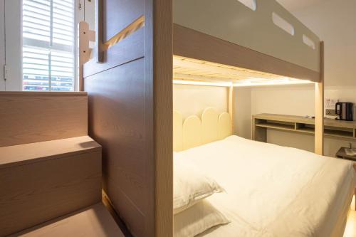a bedroom with a bunk bed and a desk at Rest Chinatown Hotel in Singapore