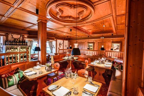 a restaurant with wooden walls and tables and chairs at Schloss Hotel Holzrichter in Nachrodt-Wiblingwerde