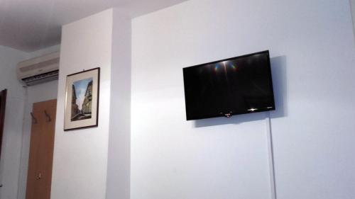 a flat screen tv hanging on a wall at Rooms Aračić in Slavonski Brod