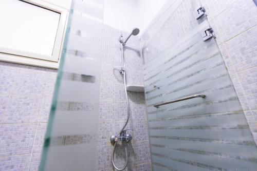 a shower with a glass door in a bathroom at Lazur Pool Apartment's - El Kawsar, Hurghada - Egypt in Hurghada