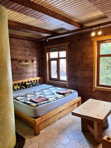 a bedroom with a bed in a wooden room at Chalet Truten in Vorokhta