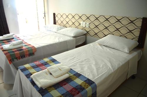 מיטה או מיטות בחדר ב-Canoas Hotel