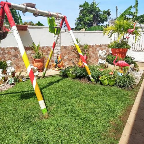 a group of colorful swings in a yard at Studio de charme à Bouillante, 100 m², vue sur mer et montagnes in Bouillante