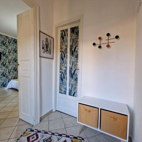 a room with a white door and a table at Casa Gran Madre in Turin