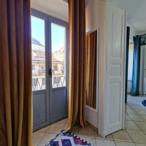an open door with a view of a balcony at Casa Gran Madre in Turin