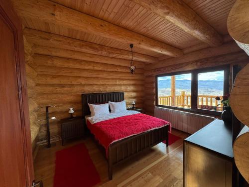 a bedroom with a bed in a log cabin at Cabana Om Bun in Piatra