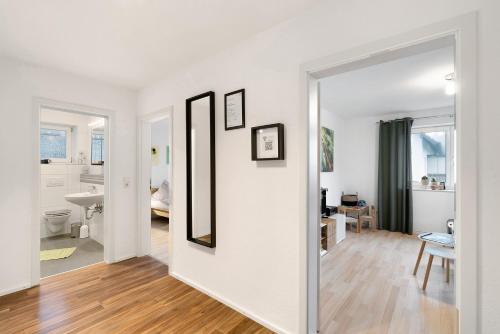 an open hallway with white walls and wood floors at Hildas Plätzchen in Oberkirch