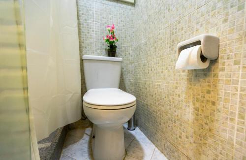 a bathroom with a toilet with a flower on the wall at Lazur Pool Apartment's - El Kawsar, Hurghada - Egypt in Hurghada