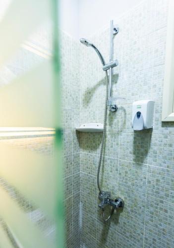 a shower in a bathroom with a soap dispenser at Lazur Pool Apartment's - El Kawsar, Hurghada - Egypt in Hurghada