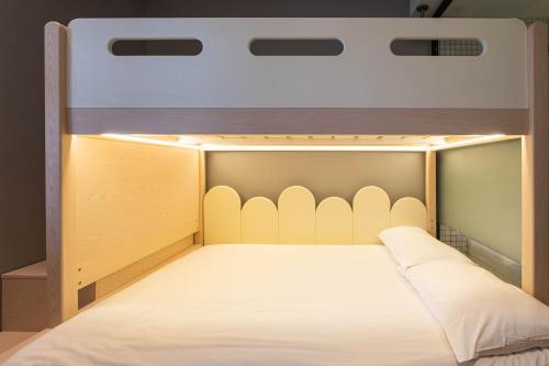 a bed with a canopy in a room at Rest Chinatown Hotel in Singapore