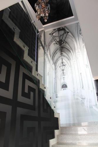 a staircase in a building with a chandelier at Astor Hotel & Spa in Bishkek