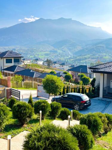 a car parked in a parking lot with a mountain at pazaric residence in Doljani