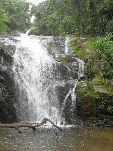 a waterfall in the middle of a river at Rancho Pôr Do Sol in Arapeí