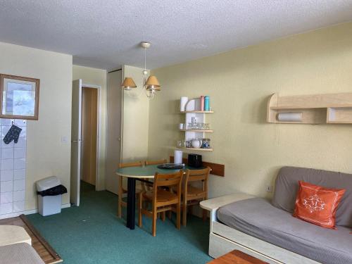 un salon avec un canapé et une table dans l'établissement Appart. skis aux pieds, sud, animaux bienvenus - FR-1-513-99, à Courchevel