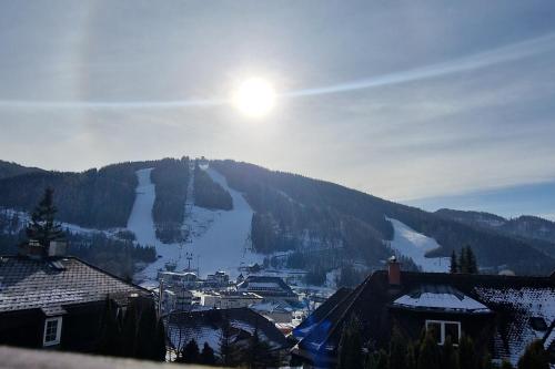 a view of a town with a snow covered mountain at Der Löffler am Semmering in Semmering