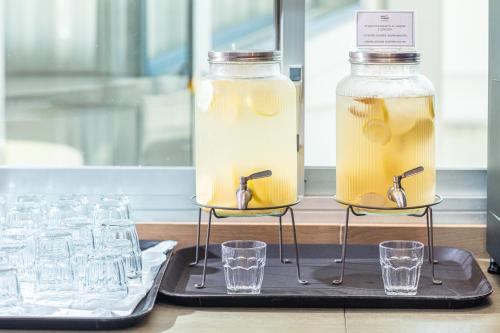 two jars of lemonade and glasses on a table at Hotel San Giorgio Resort 4S in Caorle