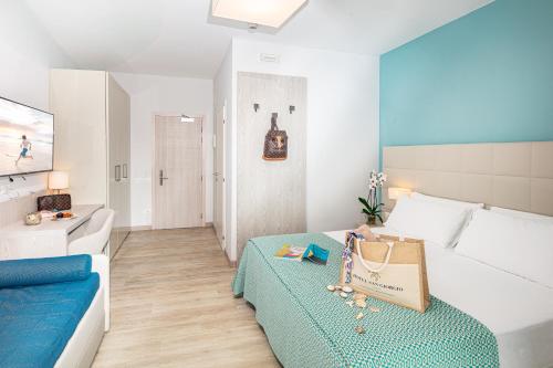a bedroom with a bed and a blue and white room at Hotel San Giorgio Resort 4S in Caorle