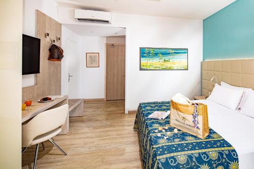 a hotel room with a bed and a desk at Hotel San Giorgio Resort 4S in Caorle