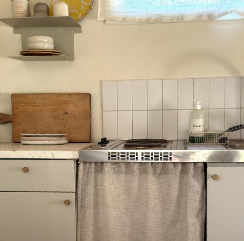 a kitchen with a stove top oven in a kitchen at Atelier Blå houses in Rösselvik